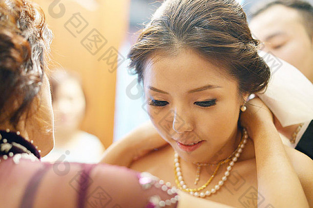 中国人婚礼仪式上了年纪的给黄金项链礼物新娘祝福