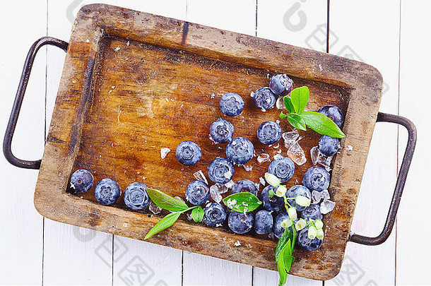 成熟的蓝莓越桔垃圾木托盘小华丽的分支白色木表格