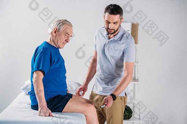 康复治疗师反射锤检查高级男人膝盖按摩表格