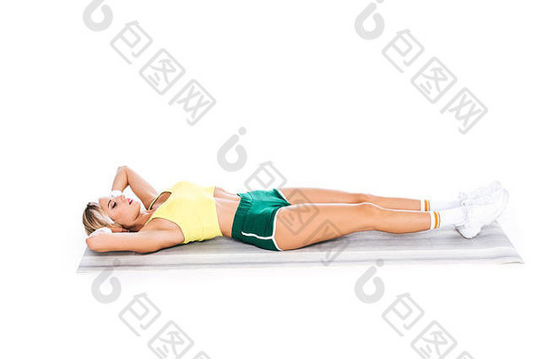 金发女郎健身教练运动服装锻炼瑜伽席孤立的白色