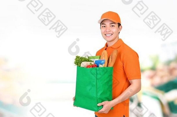 卫生微笑亚洲交付男人。携带杂货店购物袋超市背景
