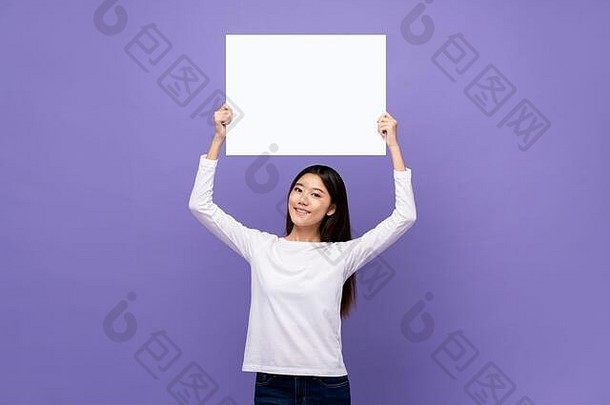 微笑可爱的年轻的亚洲女人持有白色纸榜空空间文本开销