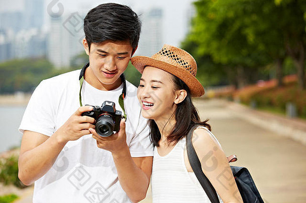 年轻的亚洲夫妇游客camera’s监控检查图片