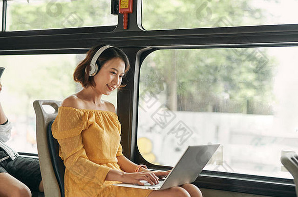 年轻的女商人业务旅行工作公共汽车移动PC