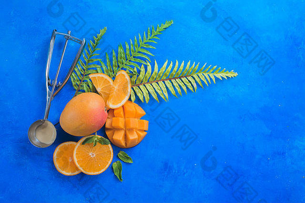 冰奶油勺子异国情调的水果芒果橙子生动的蓝色的背景复制空间成分平躺