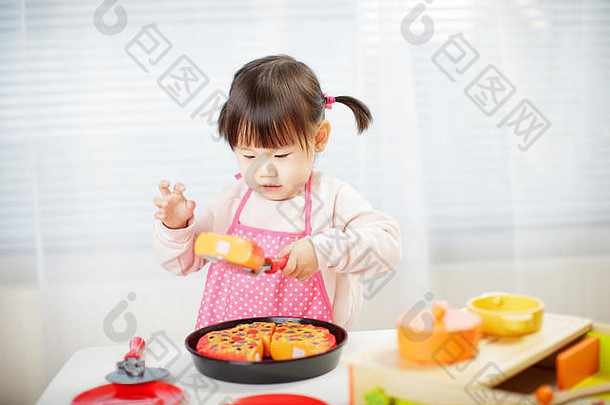 蹒跚学步的婴儿女孩假装玩食物准备