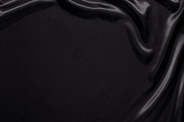 拍摄黑色的丝绸缎背景折痕涟漪平平原区域复制空间