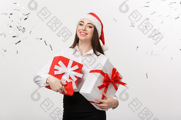 业务概念美丽的年轻的高加索人业务女人圣诞老人他持有礼物盒子五彩纸屑庆祝活动背景