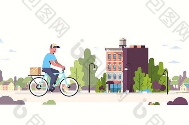 邮递员统一的骑自行车携带纸板包裹盒子快递骑自行车在户外表达交付服务概念现代城市景观背景