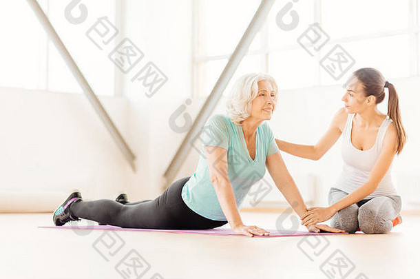积极的快乐的女人锻炼瑜伽席