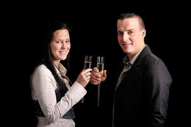 年轻的接吻夫妇玻璃香槟黑色的背景