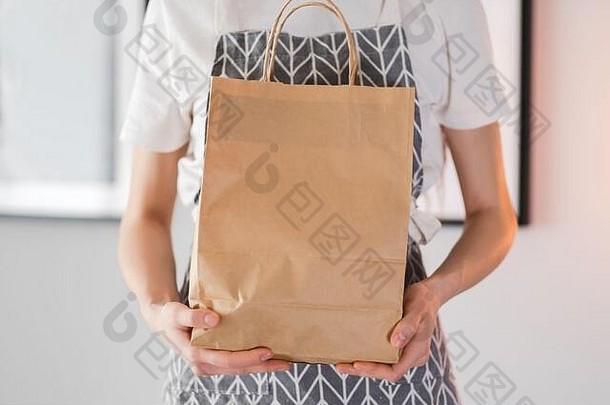 女人持有工艺生态购物袋手交付食物模拟