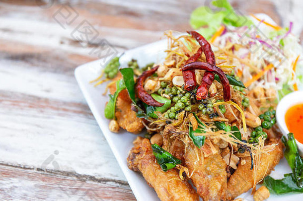 美味的美味的炸翼鸡草胡椒辣椒沙拉酱汁著名的泰国亚洲食物表格餐厅