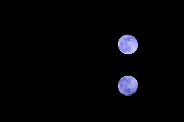 令人回味的蓝色的完整的月亮反射水
