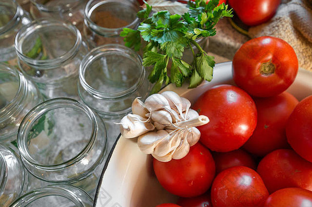 罐头新鲜的西红柿洋葱果冻腌料女人手把红色的成熟的番茄片洋葱环罐子罗勒欧芹叶子前