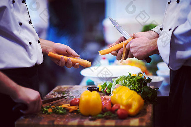 厨师手切割胡萝卜木表格准备餐餐厅