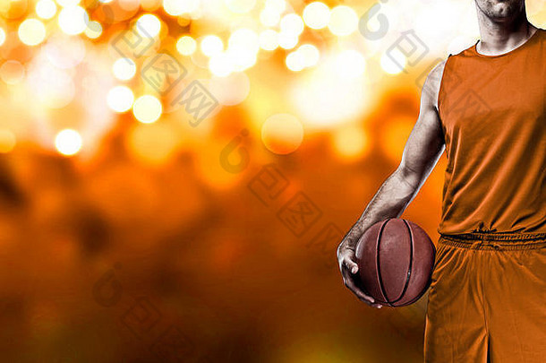 篮球球员橙色统一的橙色灯背景