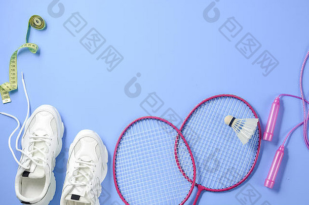 体育平躺羽毛球羽毛球球拍跳过绳子运动鞋测量磁带紫色的背景健身体育运动健康的生活