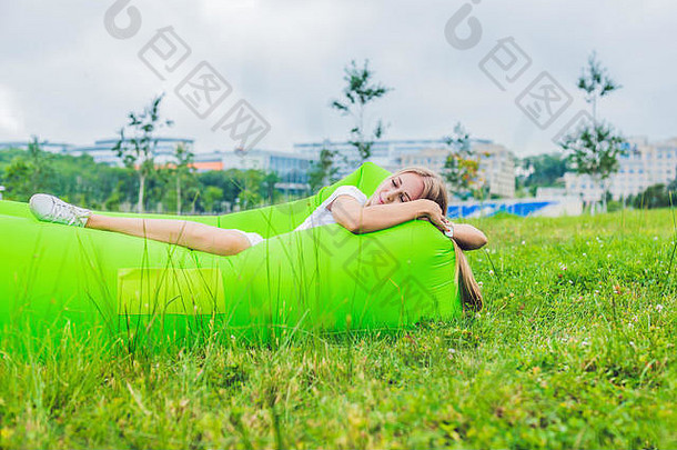 年轻的女人休息空气沙发公园