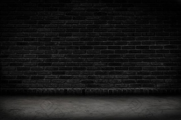 空黑色的砖墙混凝土地板上背景黑暗房间室内黑色的砖墙空白水泥地板上背景
