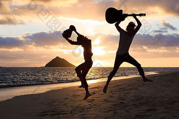 轮廓<strong>双胞胎兄弟</strong>鼓吉他跳跃空气日出夏威夷海滩