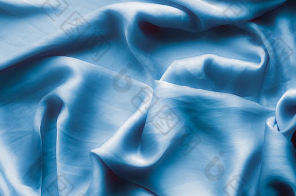 蓝色的软丝绸波平铺优雅的织物纹理摘要背景现代柔和的颜色概念感觉触摸奢侈品