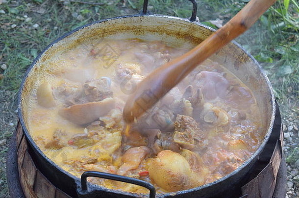 关闭热气腾腾的热炖肉烹饪木勺子