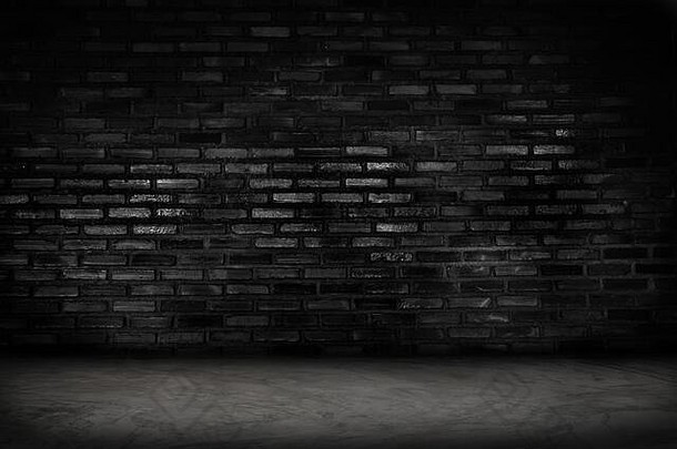 空黑色的砖墙混凝土地板上背景黑暗房间室内黑色的砖墙空白水泥地板上背景
