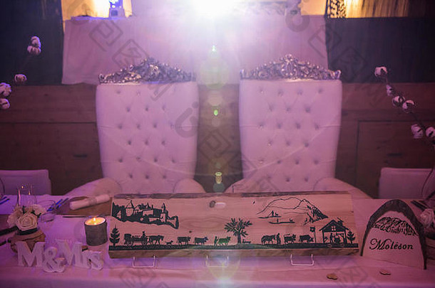 粉红色灯光下的新娘和新郎婚礼座椅和婚礼桌