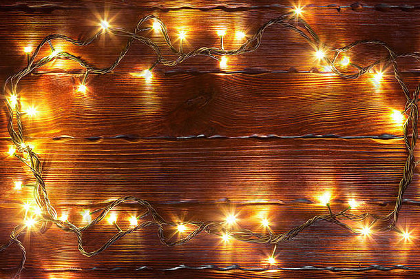 圣诞节散景<strong>背景</strong>框架发<strong>光</strong>的金加兰棕色（的）木表格分支机构圣诞节树