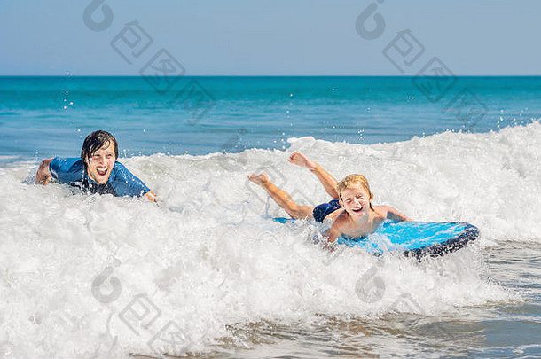 父亲教学年轻的儿子冲浪海假期假期旅行体育孩子们概念
