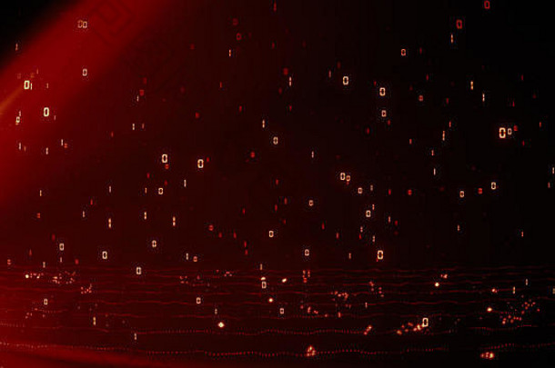 明亮的激烈的红色的发光的粒子二进制数据雨