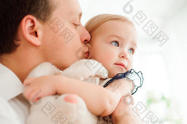 爸爸拥抱并亲吻他的小女儿。