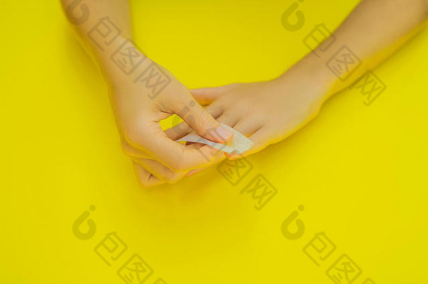 女人手护理清漆删除小指甲艺术修指甲业务前视图美丽的光滑的女人的手专业指甲护理工具修指甲黄色的背景特写镜头健康的女指甲黄色的指甲波兰的