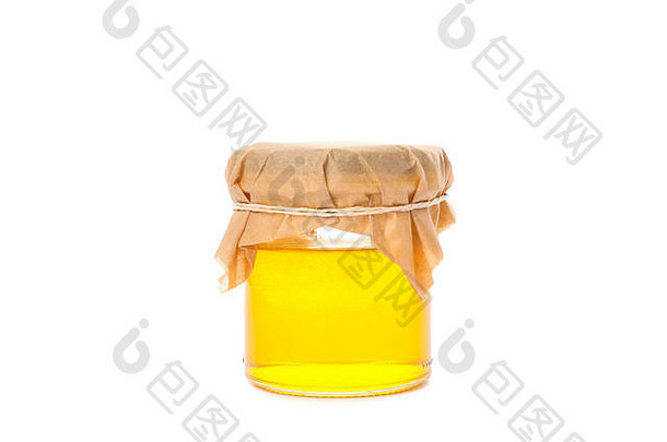 白色背景上隔离蜂蜜的玻璃罐