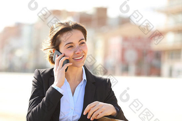快乐女商人会说话的电话坐着板凳上公园