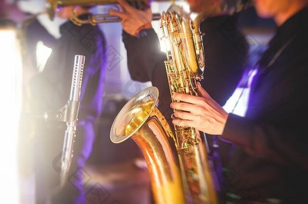 萨克斯管演奏者的音乐会视图，背景为歌手和爵士乐队