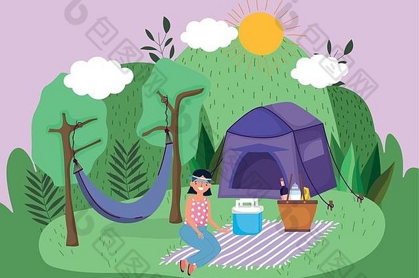 年轻女子带着帐篷篮吊床在公园里野餐