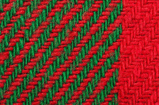 手工编织绿色和红色背景。纱线的紧密结构。圣诞色彩