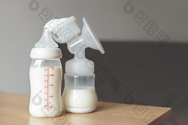 模糊背景上的母乳泵和奶瓶。妇幼保健概念。