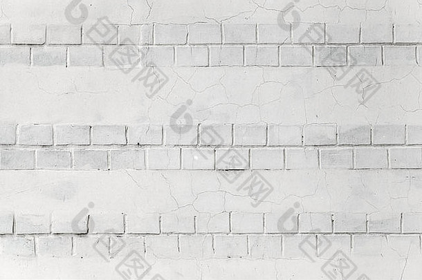 白色墙壁背景纹理，带有砖块和灰泥裂缝