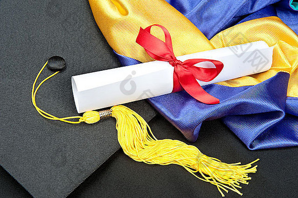 有帽子、流苏、长袍、头巾和毕业证书的毕业背景。