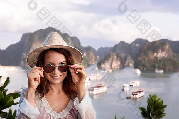 快乐年轻的女人旅游太阳镜相机海岛背景