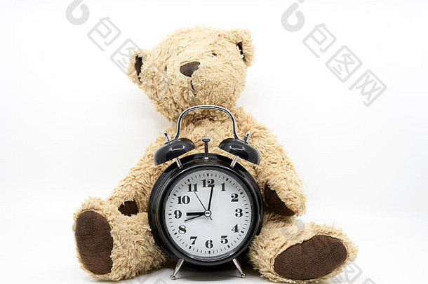 带时钟和泰迪熊的睡觉时间概念