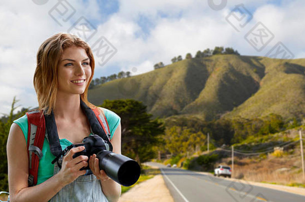 背着背包和相机在大苏尔山上空的女人