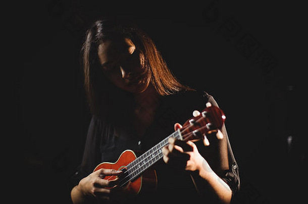 在音乐学校弹吉他的女人
