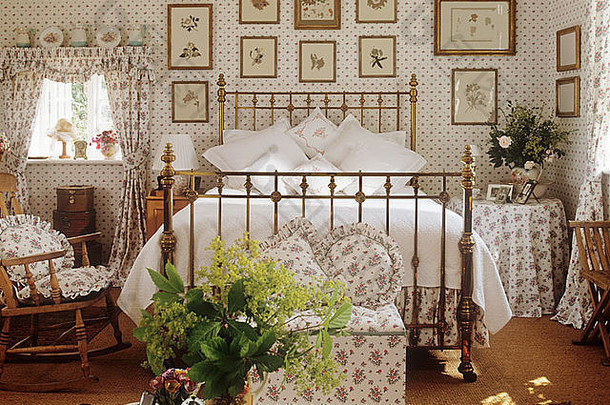 在漂亮的花卉卧室里有一张熟铁和黄铜床