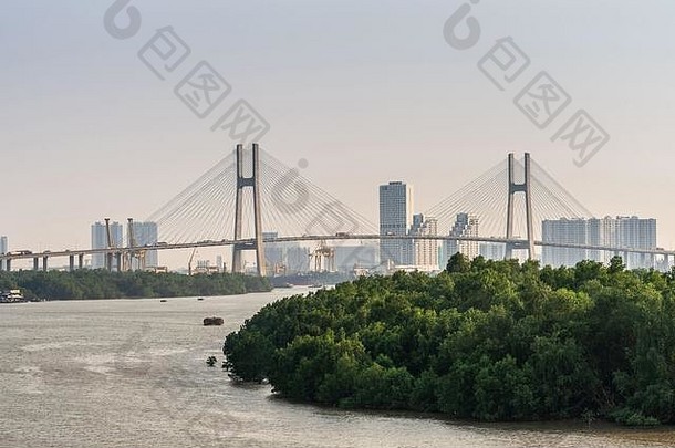 越南<strong>胡</strong>志明市——2019年3月13日：宋西贡河上拍摄的日落天空。富美吊桥上的远景，前面有绿化带