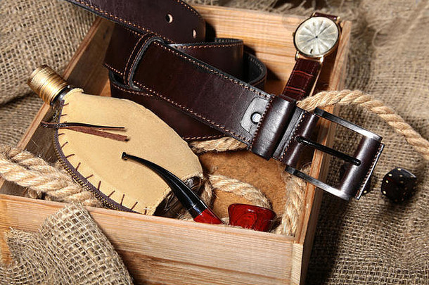 手表，皮带和钱包，木制背景上有古龙水的瓶子。时尚<strong>男士</strong>商务配饰。