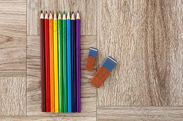 很多各种各样的颜色铅笔橡皮擦木背景彩虹